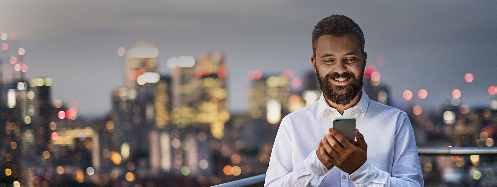 man smiling at his phone