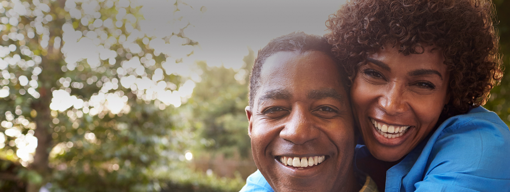 man and woman hugging and smiling