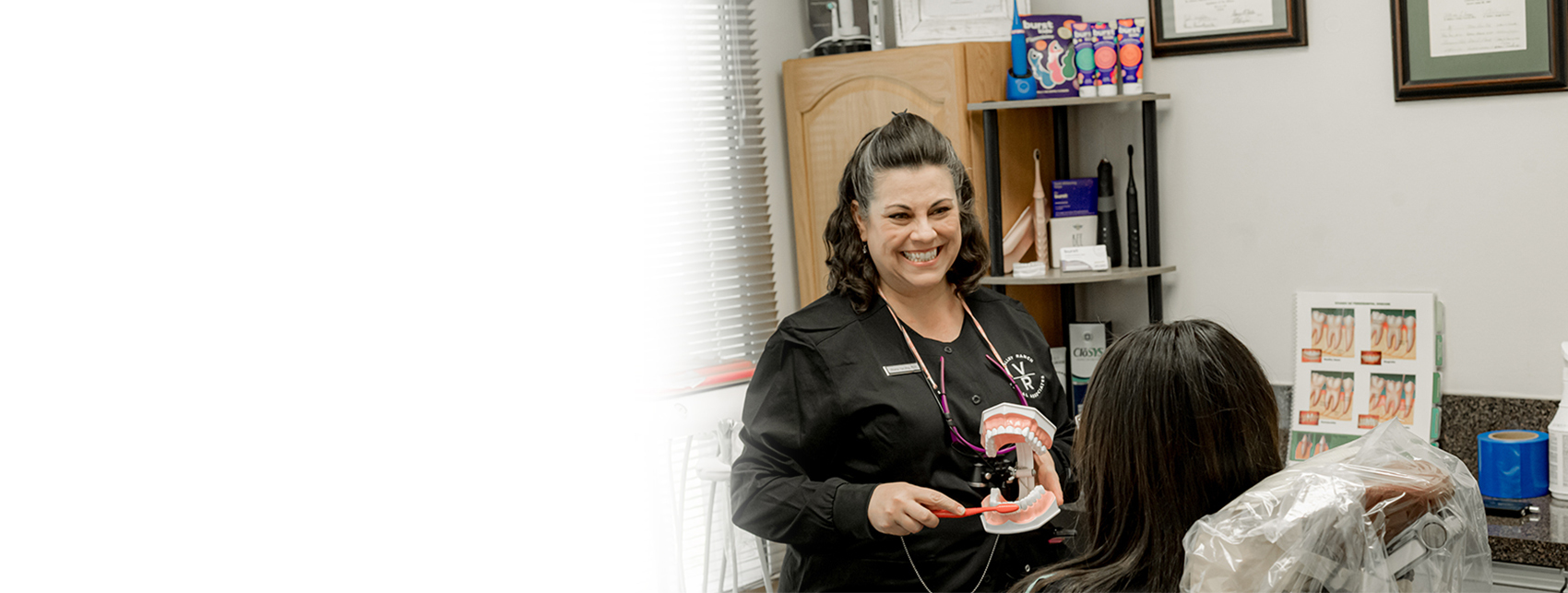 female dentist demonstrating brushing