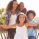 family dentist, picture of a Black family laughing