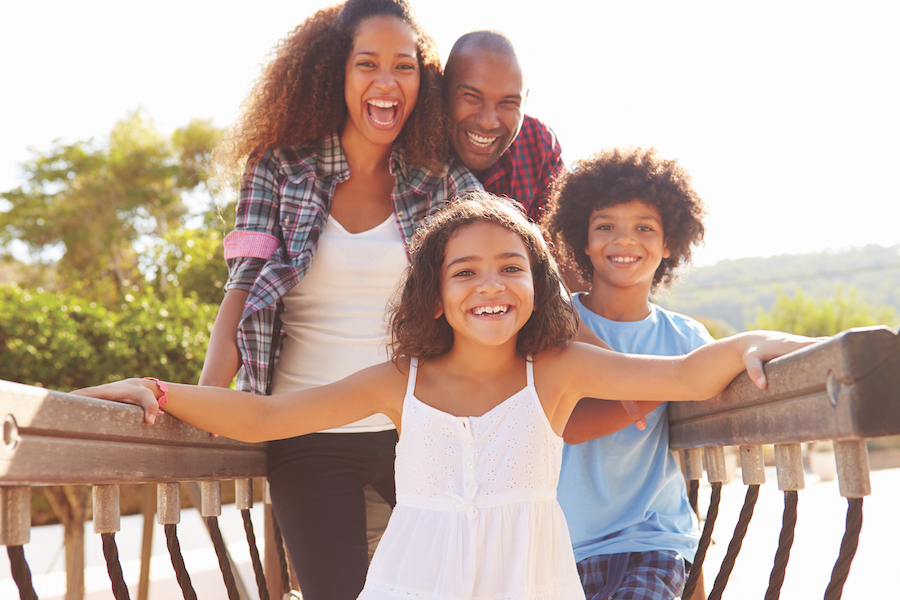 family dentist, picture of a Black family laughing