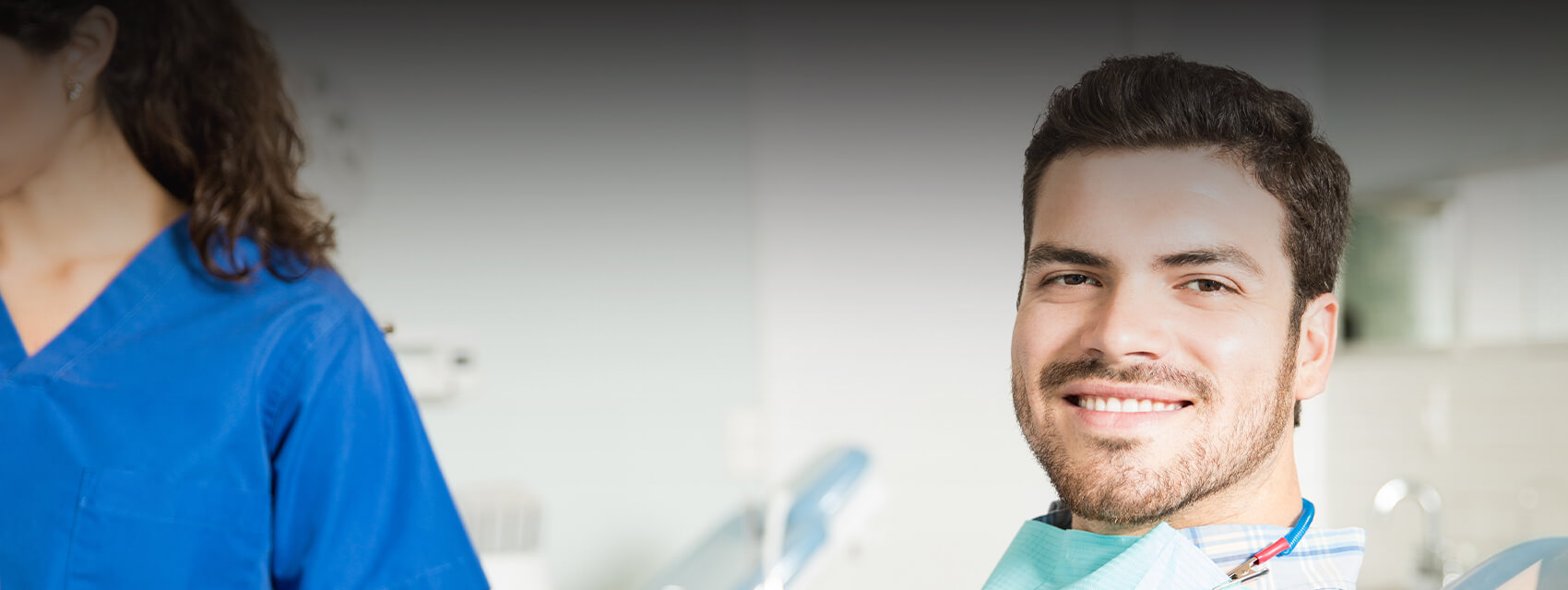 smiling man sitting in a dental chair
